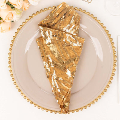Gold sequin napkin elegantly folded on a decorative plate.