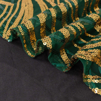 Green and gold sequin fabric with a wavy edge detail.