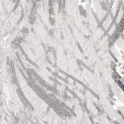 Silver sequin fabric with intricate patterns and textures.