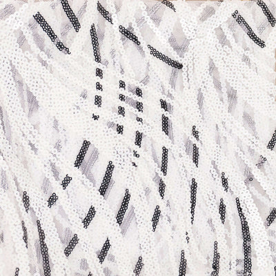 Black and white sequined fabric with intricate patterning.