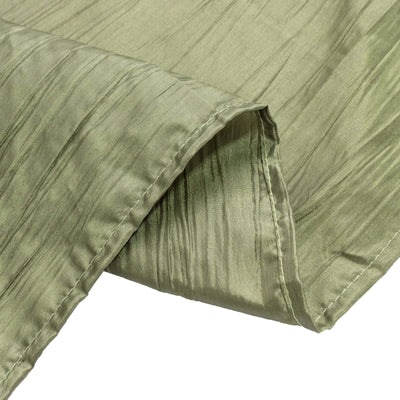 Textured green fabric with a subtle sheen and pleated design.