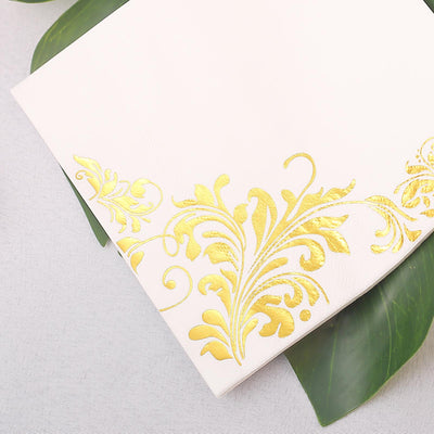 Elegant white notebook with gold floral design in the corner.