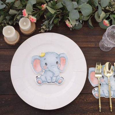 Cute elephant place card on a dinner plate with candles and greenery.