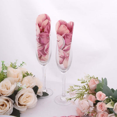 Floral champagne flutes with pink petal design and decorative flowers