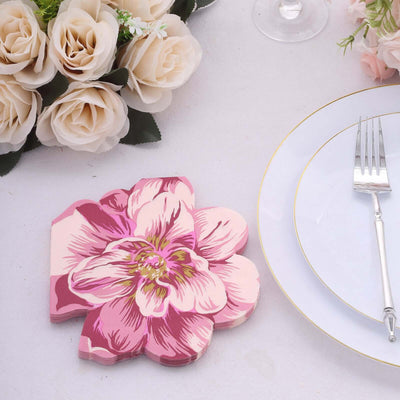 Pink floral coaster on a table with elegant dinnerware.