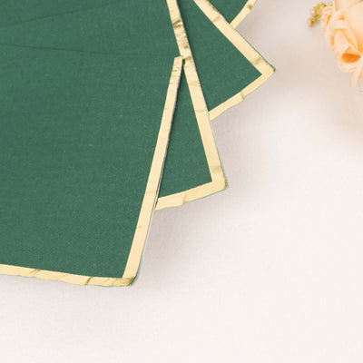 Green paper with gold edges, elegantly arranged.