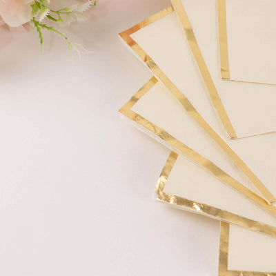 Elegant cream notecards with gold foil edges, arranged artistically.