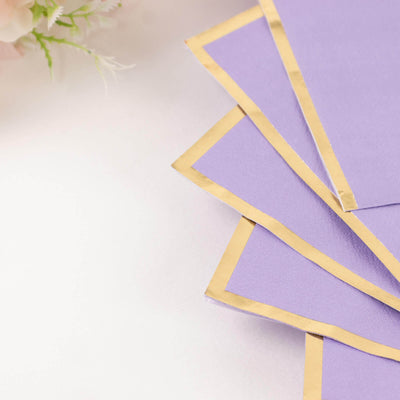 Purple paper sheets with gold edges arranged in a fan shape.
