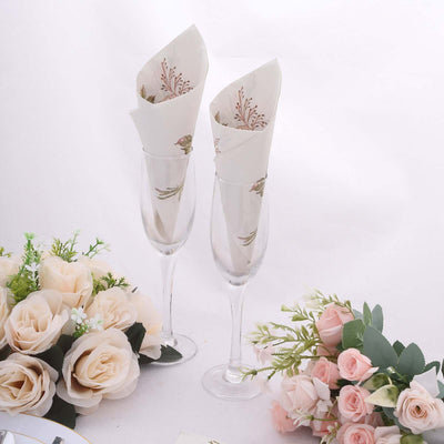 Elegant champagne flutes with decorative napkins and floral arrangements.