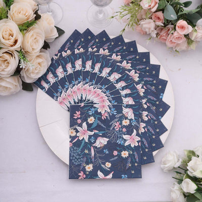 Floral navy blue stationery set displayed on a round plate with roses.