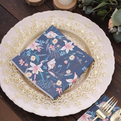 Floral patterned napkin on an elegant decorative plate.