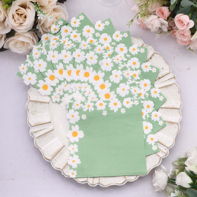 Floral patterned napkins in green on a decorative plate.