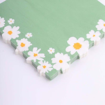 Green napkin with white daisies and orange centers on a plain background.