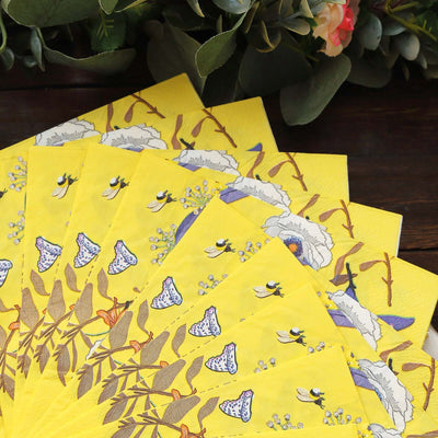 Yellow floral-patterned napkins arranged in a fan shape.