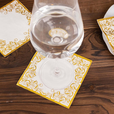 Elegant yellow and white decorative coasters with glass of water.