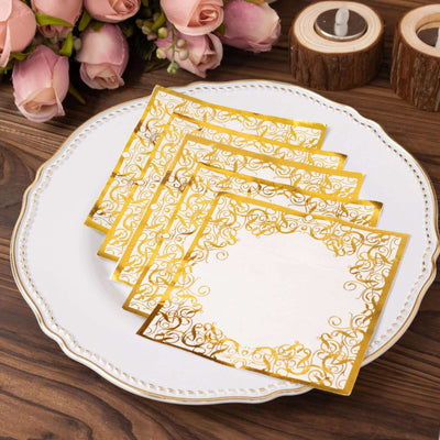 Elegant gold and white decorative napkins on a plate with flowers in the background.