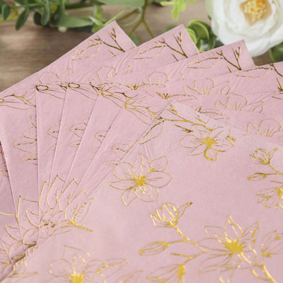 Pink floral napkins with gold foil accents arranged in a stack.