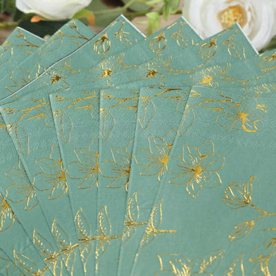 Gold-embossed floral napkins on a soft green background.