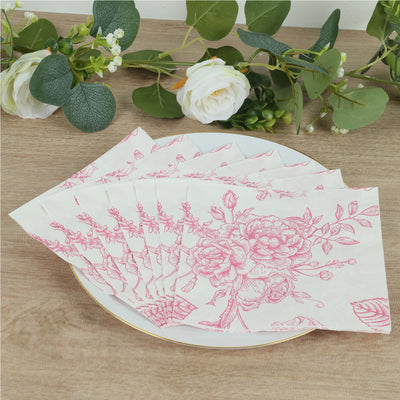 Floral-patterned paper napkins arranged on a plate with greenery backdrop.