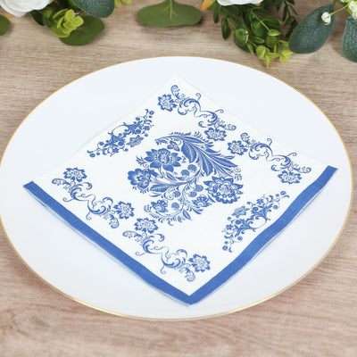 Blue floral design paper napkin on a white plate.