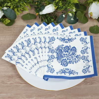 Blue floral patterned paper napkins arranged on a white plate.