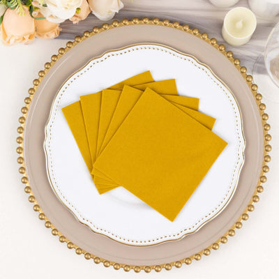 Yellow paper napkins stacked on a decorative plate.