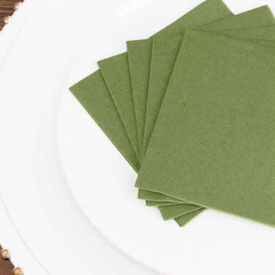 Green textured paper sheets arranged neatly on a white plate.