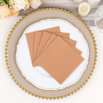 Brown kraft paper envelopes on decorative plate with floral accents.