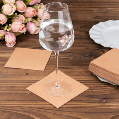 Clear glass of water on a brown paper coaster with pink roses in the background.
