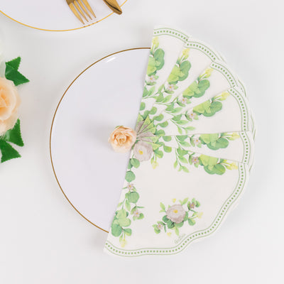 Floral napkins elegantly arranged on a white plate with a rose accent.