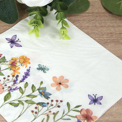 Floral napkin with colorful flowers and butterflies design on a wooden surface.