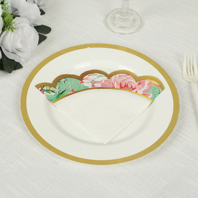 Decorative paper napkin with floral design on a gold-trimmed plate.