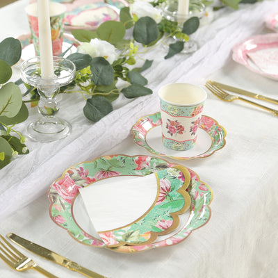 Floral disposable plates and cups set on a beautifully arranged table.