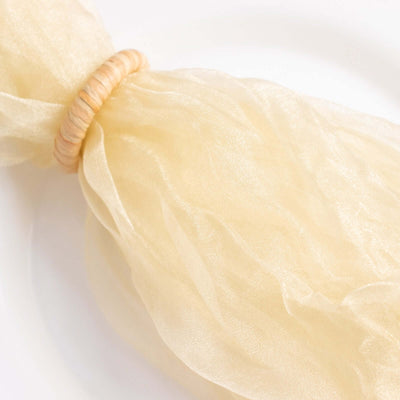 Sheer champagne-colored napkin with a natural twine ring.
