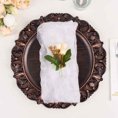 Elegant napkin wrapped with a delicate flower arrangement on a decorative plate.