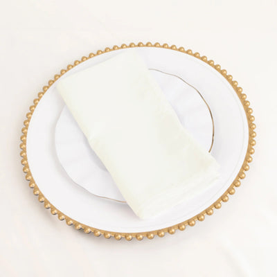 Elegant white napkin neatly folded on a decorative plate.