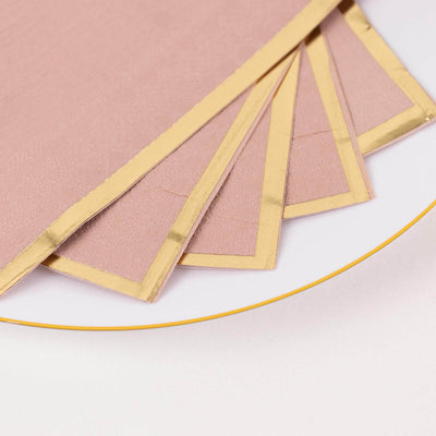 Elegant pink paper with gold foil edges on a white plate.