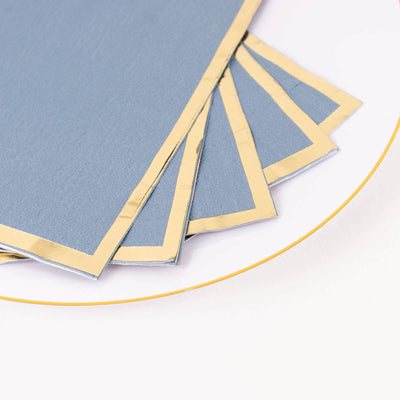Blue and gold bordered paper sheets stacked on a white background.