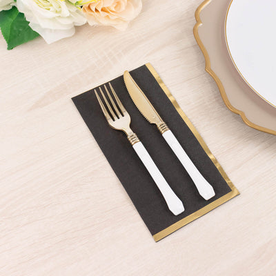 Elegant gold cutlery set on a stylish napkin with floral accents.
