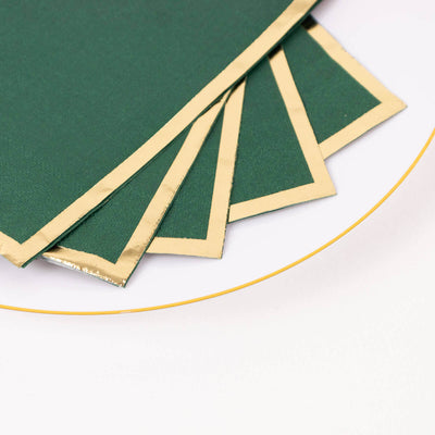 Green napkins with gold trim on a white background