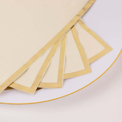 Elegant cream-colored paper napkins with gold borders, stacked neatly.