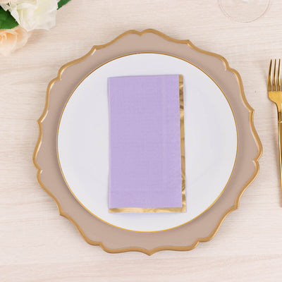 Purple napkin on an elegant plate with a gold rim.