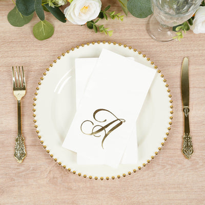 Elegant table setting with gold-accented plate and monogrammed napkin.