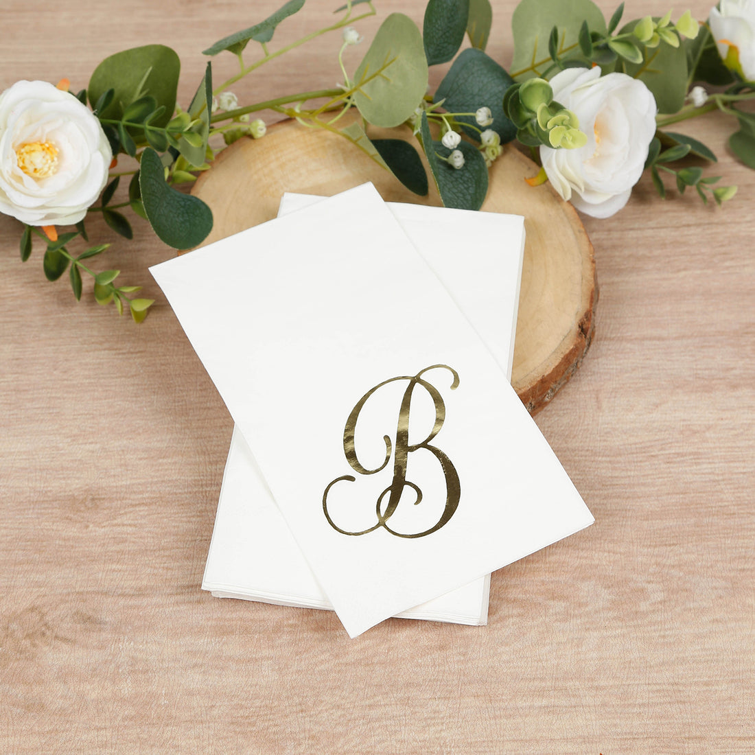 Elegant monogrammed napkins with letter "B" on a wooden surface.