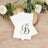 Elegant monogrammed napkins with letter "B" on a wooden surface.