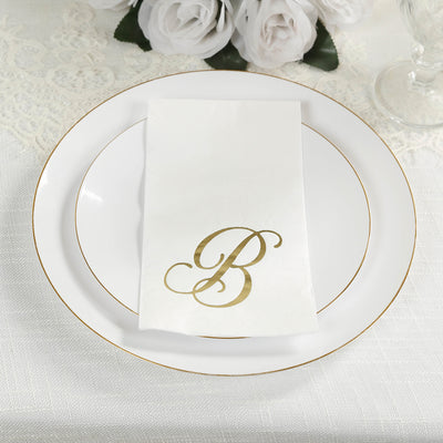 Elegant white plate with gold-trimmed napkin featuring letter "B."