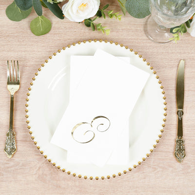 Elegant table setting with gold accents, plate, napkin, and cutlery.