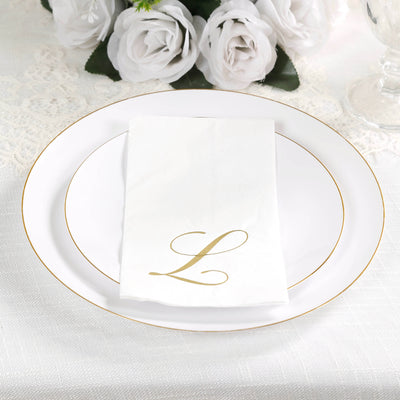 Elegant white plate with gold trim and monogrammed napkin featuring the letter "L".