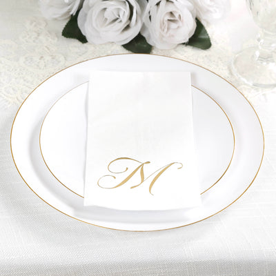Elegant white plate with gold rim and personalized napkin featuring a gold letter "M".