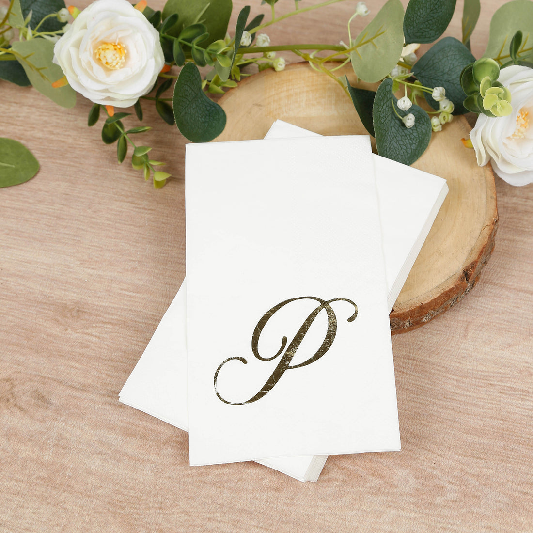 White napkins with elegant gold "P" monogram design